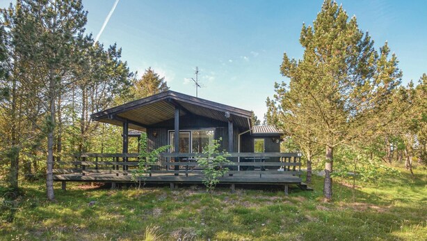 A cabin with a deck, surrounded by trees. - Amazing home in Hurup Thy with WiFi (Hurup Thy)