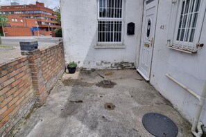 Stylish entrance with a brick wall, door, and mailbox.