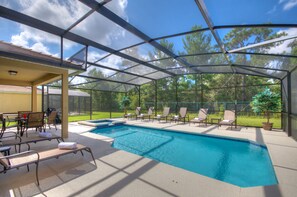 A covered outdoor swimming pool with lounge chairs and a patio area. - South Facing Pool, Near Disney, 5 Bed Luxury (Kissimmee)