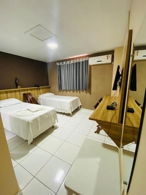 A hotel room with two beds, a desk, a chair, a mirror, and a window with curtains. - Borges Hotel (Imperatriz)