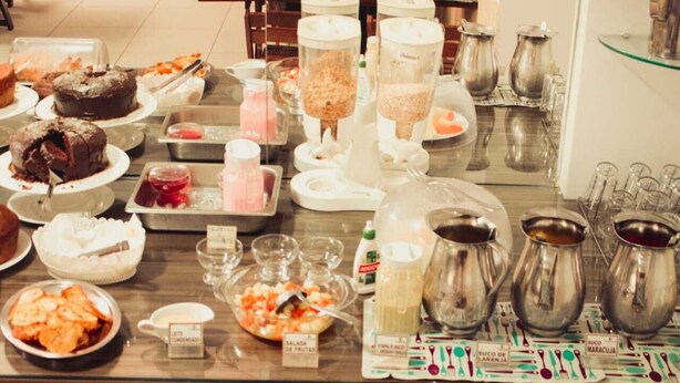 A buffet with various food items and beverages.