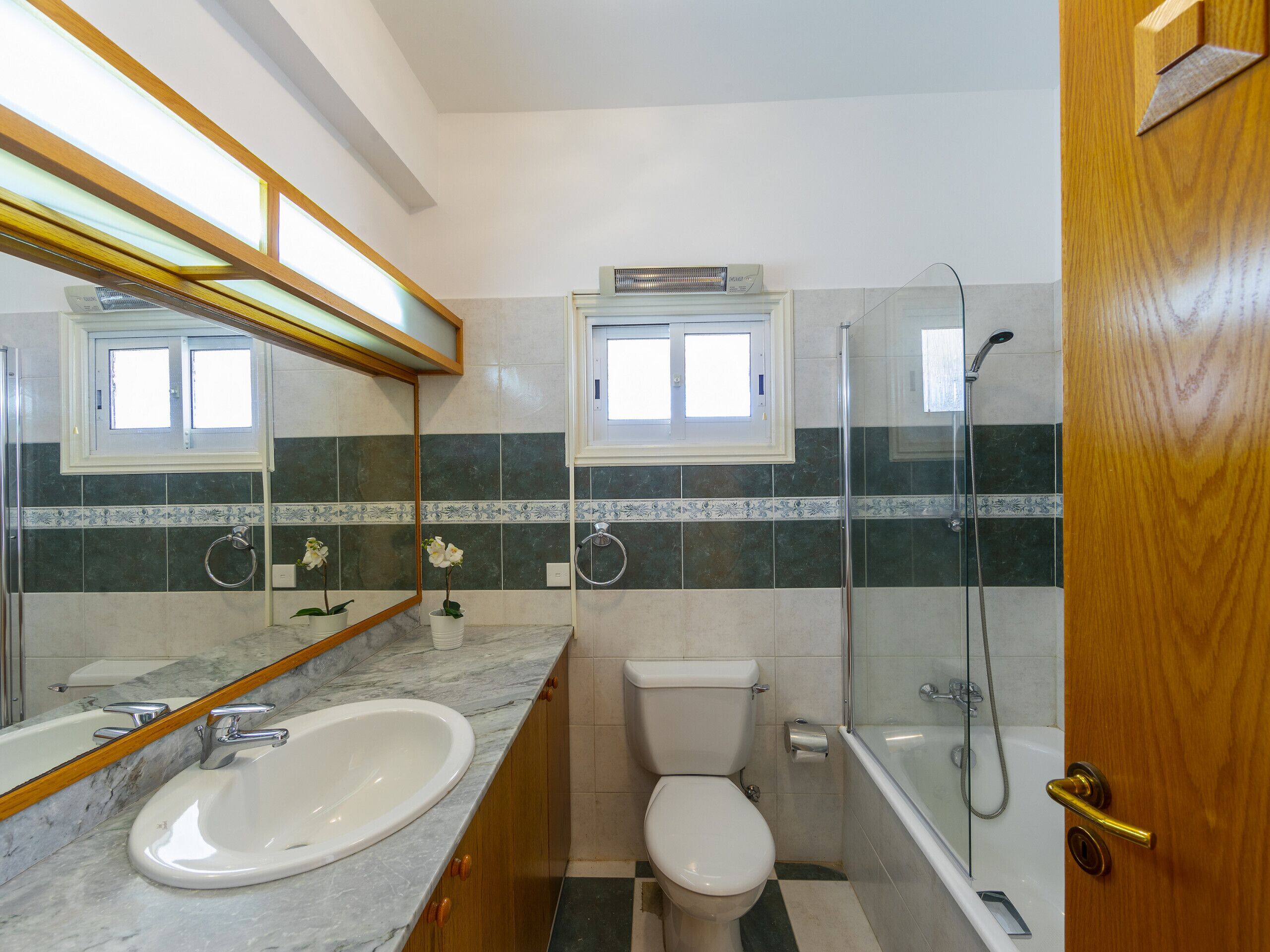 A bathroom with a sink, toilet, and shower.