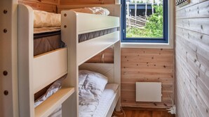 A compact, wooden-paneled room with bunk beds and a small window. - Stunning home in Sjusjøen with sauna (Sjusjøen)