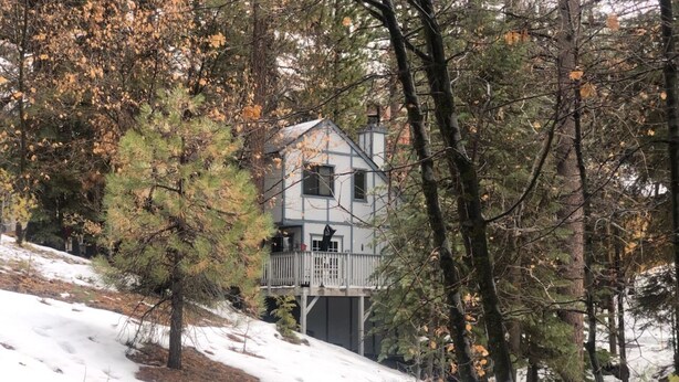 A cabin with a balcony, surrounded by trees and snow. - Somethings old, somethings new, clean and cozy just for you. (ArrowBear)