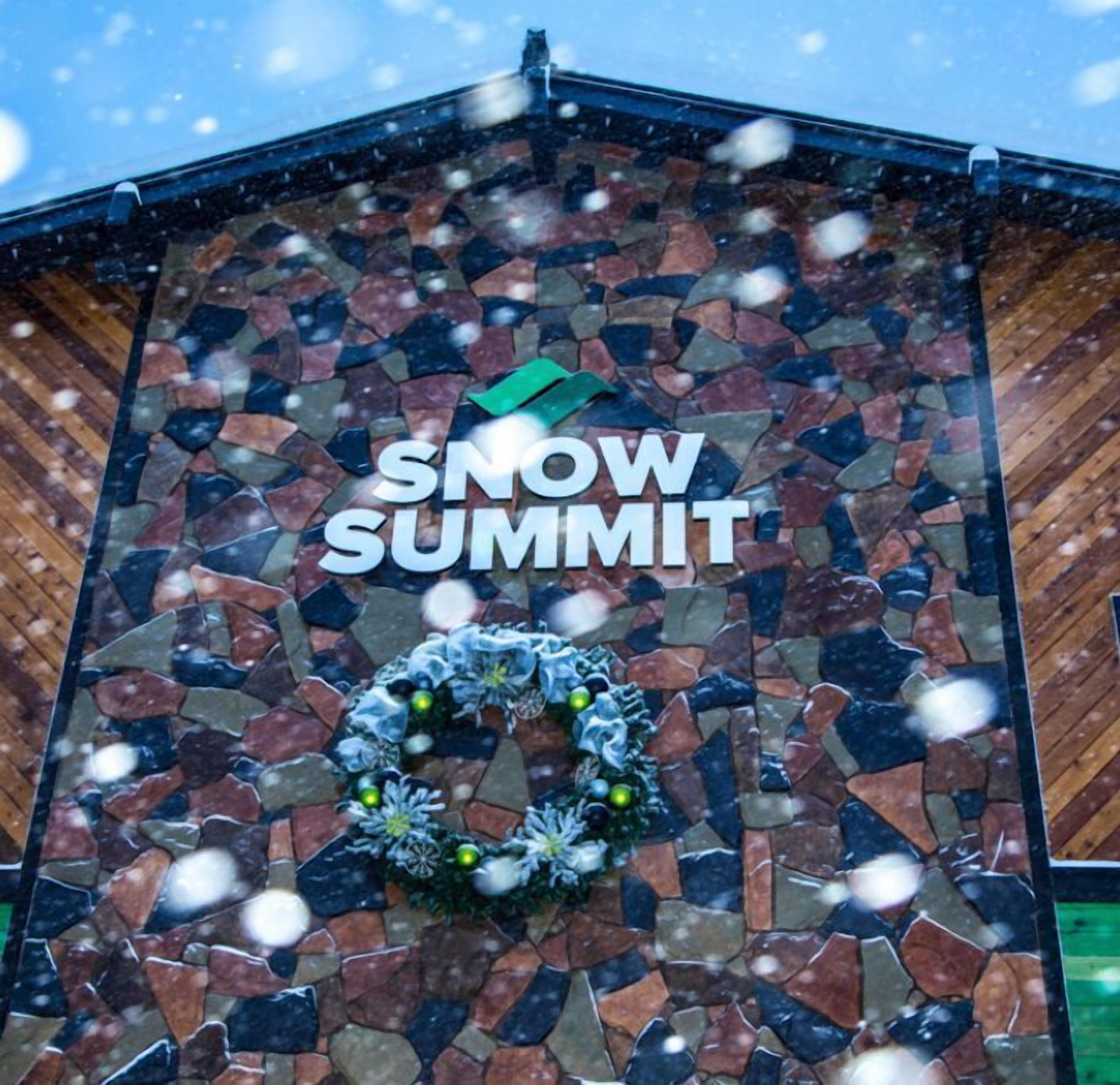 A building facade with a mosaic pattern and the text "SNOW SUMMIT" prominently displayed.
