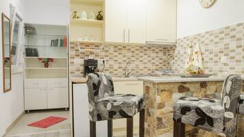 Fridge, microwave, coffee/tea maker, cookware/dishes/utensils