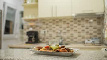 Fridge, microwave, coffee/tea maker, cookware/dishes/utensils