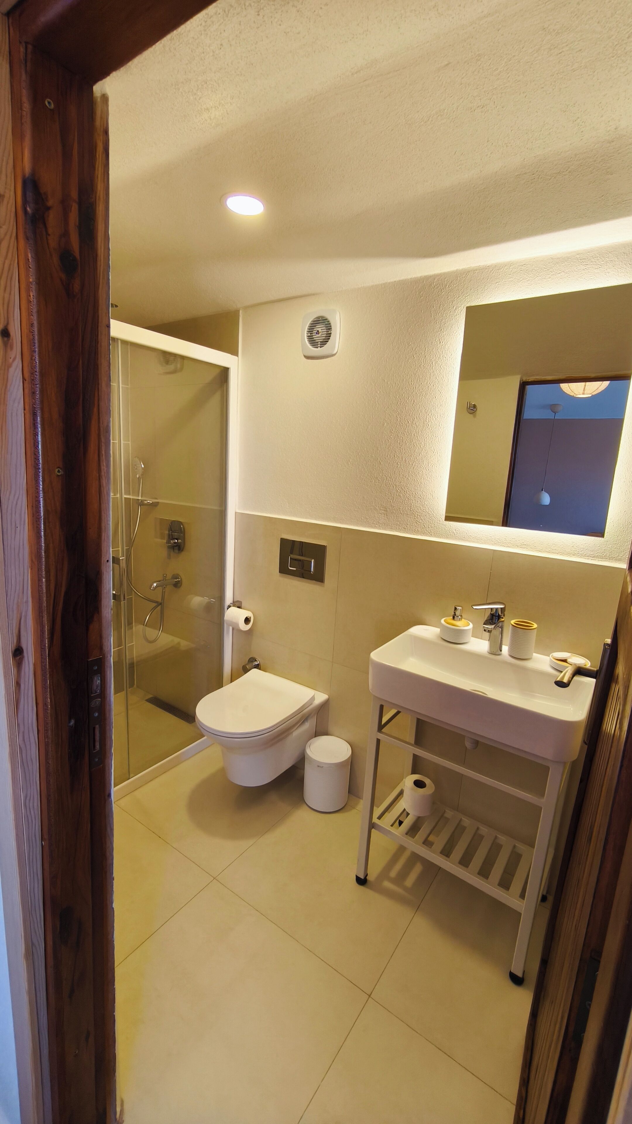 A bathroom with a shower, toilet, and sink.