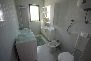 A bathroom with a toilet, bidet, sink, and a cabinet. - Comfortable Apartment for 5 Persons (Zadar)
