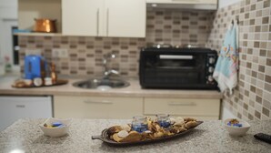 A kitchen with a microwave, toaster, and a tray of food on the counter. - A home witha view Sky -attic (Mostar)