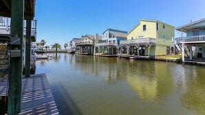 A waterfront property with multiple buildings, docks, and a calm water body. - Jamaica Beach! Fishing light, kayaks, pool access! (Jamaica Beach)