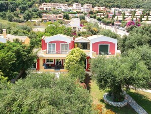 A residential area with multiple houses, some with balconies and others with front gardens.
