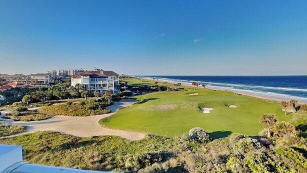 A coastal golf course with a clubhouse, ocean views, and a clear sky. - Cinnamon Beach 4 by Distinctive Beach Rentals (Palm Coast)