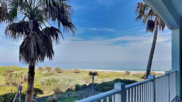 A balcony with a view of the ocean and beach vegetation. - Cinnamon Beach 4 by Distinctive Beach Rentals (Palm Coast)