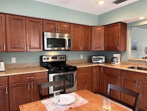 Enjoy cooking and dining in this well-equipped kitchen with a sink, oven, toaster, and coffee maker.