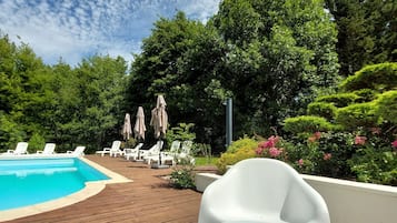 Seasonal outdoor pool, open 4:00 PM to 7:00 PM, pool loungers