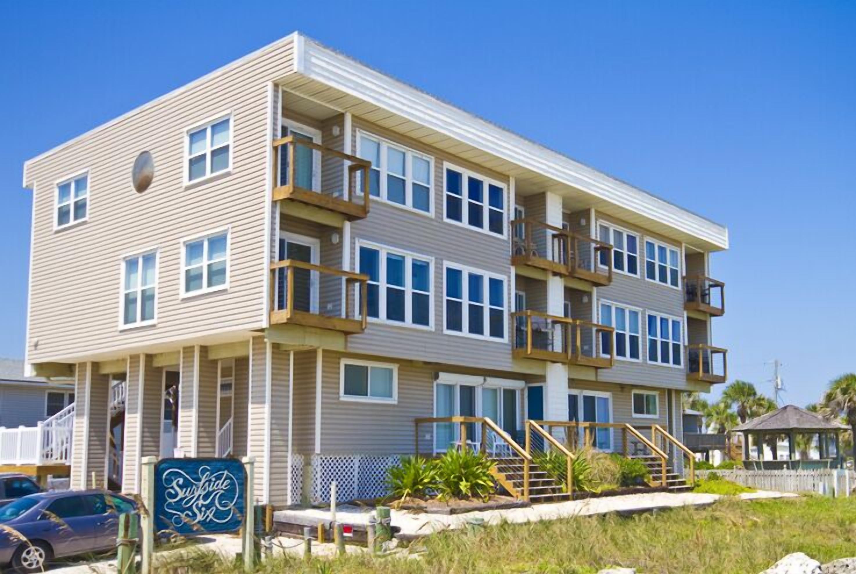 A multi-story hotel with a flat roof, balconies, and a sign indicating it is a 'Sundive' property.