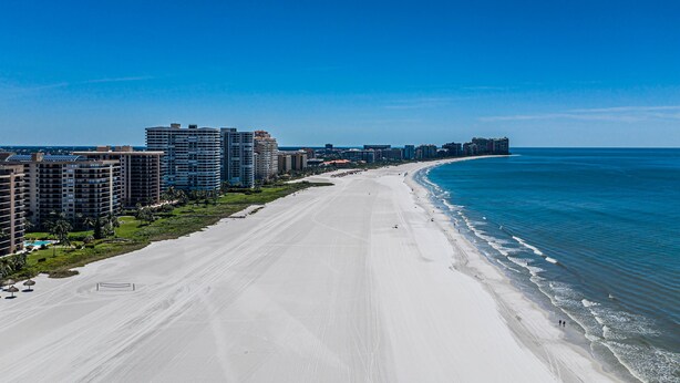 A wide beach with high-rise buildings along the shore. - THE WAVES HOUSE! 7 minute walk to the beach, 2 minute walk to the JW Marriott   (Marco Island)