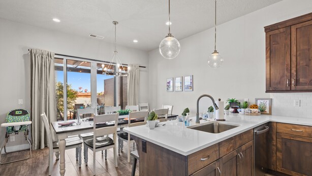 A modern kitchen with wooden cabinets, a white countertop, and pendant lighting. - Ocotillo Springs Resort 69: 3bd, 3.5 bath with a Private Hot Tub, Fire Pit, and Private Patio (Santa Clara)