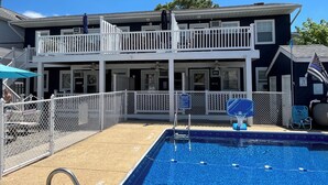A two-story building with a pool, a fenced deck, and a sign indicating a restaurant. - AUGUST 8 TO 11 AVAILABLE ...  FAMILIES/COUPLES ONLY  
CUTE UNIT WITH POOL (Seaside Heights)