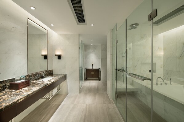 A modern bathroom with a marble countertop, a large mirror, a glass shower enclosure, and a wooden vanity. - Crowne Plaza Yading by IHG (Garze)