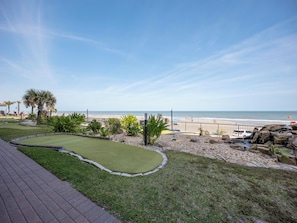 A golf course with a view of the beach and ocean.