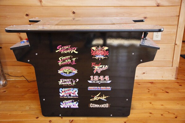 A black table with various video game and comic book stickers.