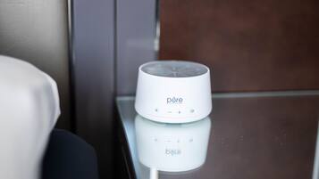 A white device on a reflective surface, possibly a charging station or a speaker, with the brand name 'pore' visible.