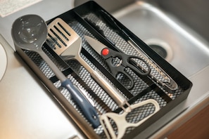 A kitchen utensil tray with a spatula, tongs, and a ladle. - Ferio101 (Tokyo)