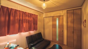A modern room with a sofa, a small table, and a wardrobe. - Ferio101 (Tokyo)