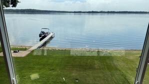 A view from a window overlooking a calm lake with a dock and grassy area. - View are amazing that is what our guests say
5 Minutes to the Freeway and town (Rush City)