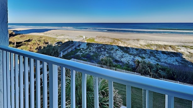 A balcony with a view of a beach and ocean. - Jacksonville Beachdrifter by Distinctive Beach Rentals (Jacksonville Beach)