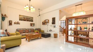 A spacious living room with a sofa, coffee table, and decorative items. - Wild Fun Hualien (Ji'an)