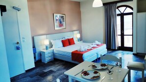 A hotel room with a bed, bedside tables, a dining table with plates and cutlery, and a window with curtains. - Creta Sun Studios - Adults Only (Chania)