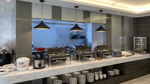 A modern breakfast bar with multiple food stations, including a coffee machine and a rice cooker. - Sun Motel (Kaohsiung)