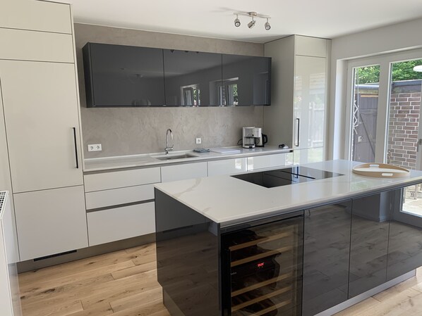 Fridge, stovetop, dishwasher, coffee/tea maker