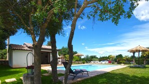 A swimming pool with lounge chairs, a small shed, and a house with a tiled roof. - House 2041/31790 (Istria - Rovinj), 1000m from the beach (Rovinj)