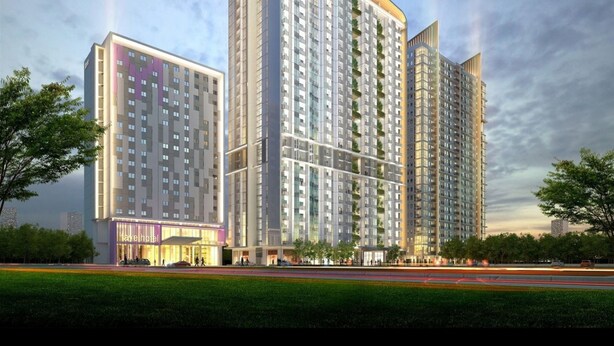A modern hotel with multiple high-rise buildings, featuring a prominent entrance with a purple facade and a well-maintained garden area in front. - Mahogany x Sagita Karawang by Zuzu (Karawang)