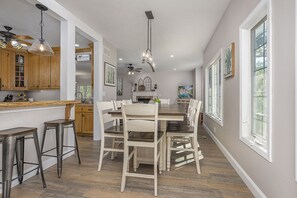 Enjoy meals in this stylish kitchen and dining area, featuring a large table and modern appliances.