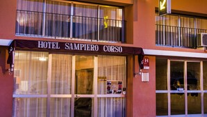 A hotel named "Sampiero Corso" with a sign above the entrance and a balcony with railings. - Sampiero Corso (Corte)