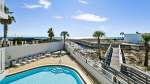 A pool area with a view of the beach and ocean. - 201AB Seacrest is a Gulf Front 3 BR by RedAwning (Fort Walton Beach)