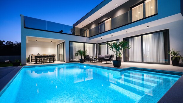 A modern two-story house with a swimming pool, outdoor furniture, and large windows. - Villa Antonia (Kastela)