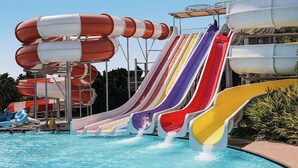 A water park with multiple water slides and a pool. - such as beach (Roquetas de Mar)
