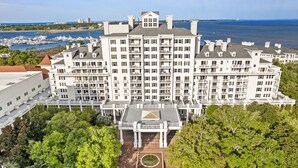 A large, multi-story hotel with a symmetrical facade, multiple balconies, and a central courtyard. - Golf Cart ~ 2nd Floor Studio ~ Kitchenette (Miramar Beach)