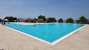 A rectangular swimming pool with clear blue water, surrounded by a tiled deck. - Dimora Miralago -  with panoramic view of the lake (San Zeno Di Montagna)