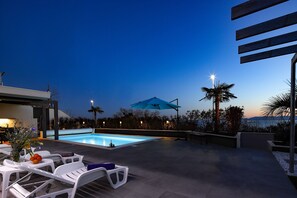 Outdoor pool, a heated pool - Beachfront Luxury Apartment , salty water heated pool (Paveki)