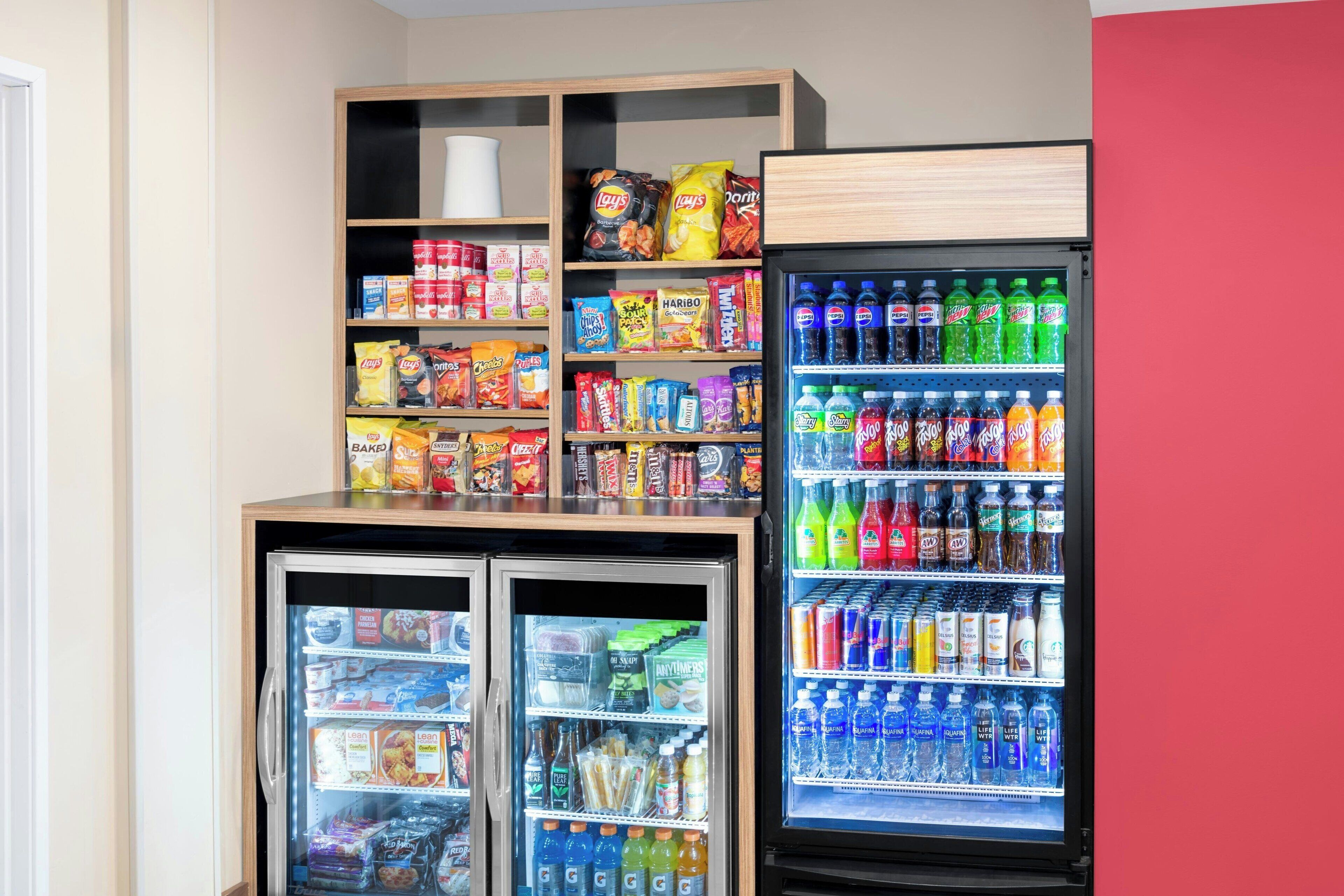 A vending machine stocked with snacks and beverages, including chips, cookies, and sodas.