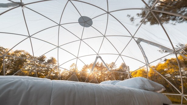 A dome-shaped room with a bed and a circular skylight. - ComfyDome Forest-Side Glamping (Jefferson)
