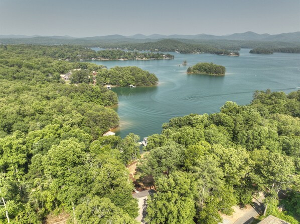 An aerial view of a forested area with a lake, surrounded by hills. - Lake Blue Ridge Cabin Sleeps 10 with Private Dock! (Blue Ridge)