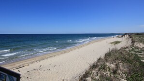 Ein Strand mit einer Holzpromenade entlang des Ufers.